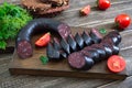 Morsilla - blood sausage. Pieces of Spanish black pudding on a wooden cutting board. Easter menu Royalty Free Stock Photo