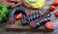 Morsilla - blood sausage. Pieces of Spanish black pudding on a wooden cutting board. Easter menu Royalty Free Stock Photo