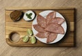 MORTADELLA SLICES APPETIZER, SERVED WITH LEMON AND PEPPER SAUCE Royalty Free Stock Photo