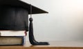 Mortar board and degree paper on wood table. Royalty Free Stock Photo