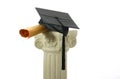 Mortar board and diploma on pedestal II