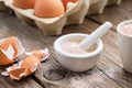 Mortar of crushed eggshell, cardboard box of eggs. Whole and powdered eggshells, natural calcium. Royalty Free Stock Photo