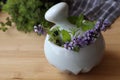 Mortar with fresh lavender flowers, herbs and pestle on wooden table, closeup Royalty Free Stock Photo