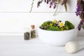 Mortar with healing herbs and pestle on white table Royalty Free Stock Photo