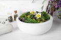 Mortar with healing herbs and pestle on white table, closeup Royalty Free Stock Photo