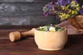 Mortar with healing herbs and pestle on table Royalty Free Stock Photo