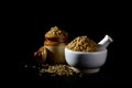 Coriander Powder and seeds with mortar and pestle on black background Royalty Free Stock Photo