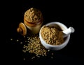 Coriander Powder and seeds with mortar and pestle on black background Royalty Free Stock Photo