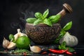 Mortar and pestle. Fresh herbs and spices on black stone table Royalty Free Stock Photo