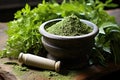 mortar and pestle with ground herbs