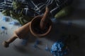 mortar and pestle making essential oils with blue flower petals and avocado with basil on white marble Royalty Free Stock Photo