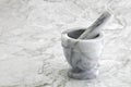 Mortar and pestle on marble kitchen surface Royalty Free Stock Photo