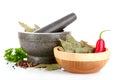 Mortar and pestle, parsley, pepper on white Royalty Free Stock Photo