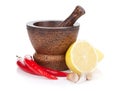 Mortar and pestle with red hot chili pepper and lemon Royalty Free Stock Photo