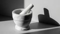 Mortar and pestle set in a minimalist setting. The mortar is rounded and Royalty Free Stock Photo