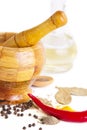 Mortar with pestle, variety of spices and oil Royalty Free Stock Photo