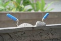 Mortar pile on trowels put on a brick block wall in construction site Royalty Free Stock Photo