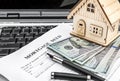 Mortgage deed with model of house on laptop keyboard Royalty Free Stock Photo