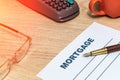 Mortgage form with a steel pen and glasses on the desk Royalty Free Stock Photo