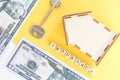 mortgage, insurance, loan and home purchase. Model of house, dollar bills, key on white and yellow isolated background. Free space Royalty Free Stock Photo