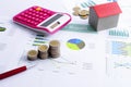 Mortgage loan concept with Coins stack and calculator and red house model Royalty Free Stock Photo