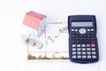 Mortgage loans concept with calculator and paper house and coins