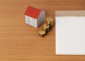 Mortgage loans concept with paper house with coins stack and not