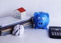 Mortgage loans concept with piggy bank and paper house on bill p