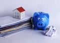 Mortgage loans concept with piggy bank and paper house on bill p