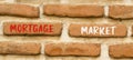Mortgage market symbol. Concept words Mortgage market on beautiful brown brick wall. Beautiful brown brick wall background.