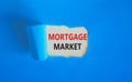 Mortgage market symbol. Concept words Mortgage market on beautiful white paper. Beautiful blue paper background. Business mortgage