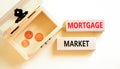 Mortgage market symbol. Concept words Mortgage market on beautiful wooden blocks. Beautiful white table white background. Wooden