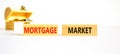 Mortgage market symbol. Concept words Mortgage market on beautiful wooden blocks. Beautiful white table white background. Wooden