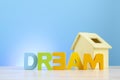 DREAM BIG word on wooden desk blue background Royalty Free Stock Photo