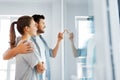 Happy couple looking through window at new home Royalty Free Stock Photo