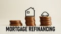 Mortgage Refinancing is shown using the text and photo of the coins and picture of the house