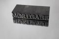 Mortgage spelled with Metal Type Reflection