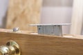 Mortise lock is inserted halfway into the wooden door. Royalty Free Stock Photo