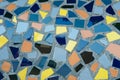 Mosaic of broken tiles on grey background outside. Textured colourful floor Royalty Free Stock Photo