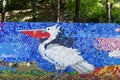 Mosaic with a dalmatian pelican or pelecanus crispus figure made of waste plastic caps