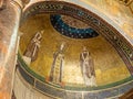 Mosaic decorating dome interior in roman catholic church showing three catholic saints Royalty Free Stock Photo