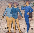 A mosaic depicting a schoolchildren with a sports equipment in an old school shabby brick wall. Royalty Free Stock Photo