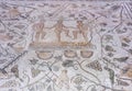 Mosaic depicting three men treading grapes to make wine at House of the Amphitheatre. Merida, Spain