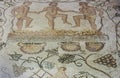 Mosaic depicting three men treading grapes to make wine at House of the Amphitheatre. Merida, Spain