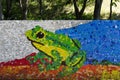 Mosaic with a evropean tree frog or hyla arborea figure made of waste plastic caps