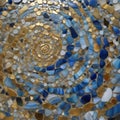 mosaic in the guell A spiral mosaic of blue and gold. The spiral mosaic is made of small pieces of agate and granite, Royalty Free Stock Photo