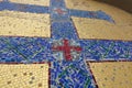 Mosaic image of the Orthodox cross with elements of vegetation. Blue cross on a golden background Royalty Free Stock Photo