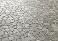 A mosaic pattern consisting of irregularly shaped, shiny beige tiles forms a Royalty Free Stock Photo