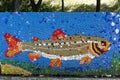 Mosaic with a river trout or salmo trutta fario figure made of waste plastic caps