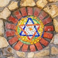 Mosaic star of David on stone wall